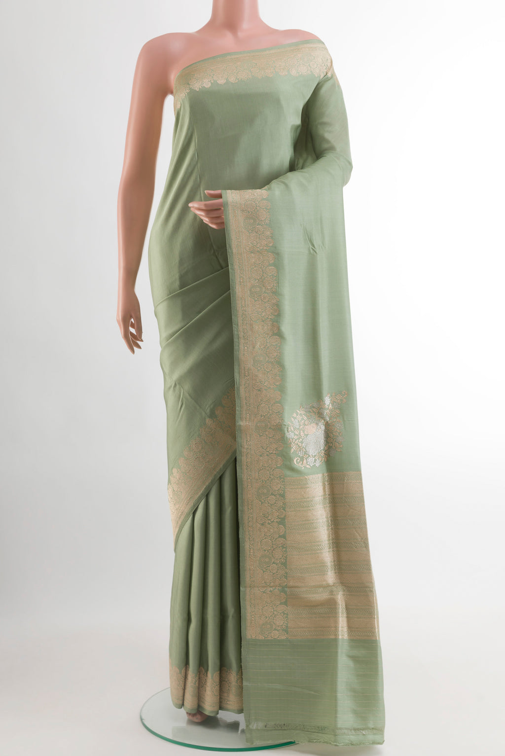 Sage Green Banarasi Silk Saree with Plain Body and Zari Border.  displayed on a mannequin