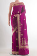 Pure Silk Magenta Banarasi Saree with Zari Butta on the body and Zari Border.  displayed on a mannequin