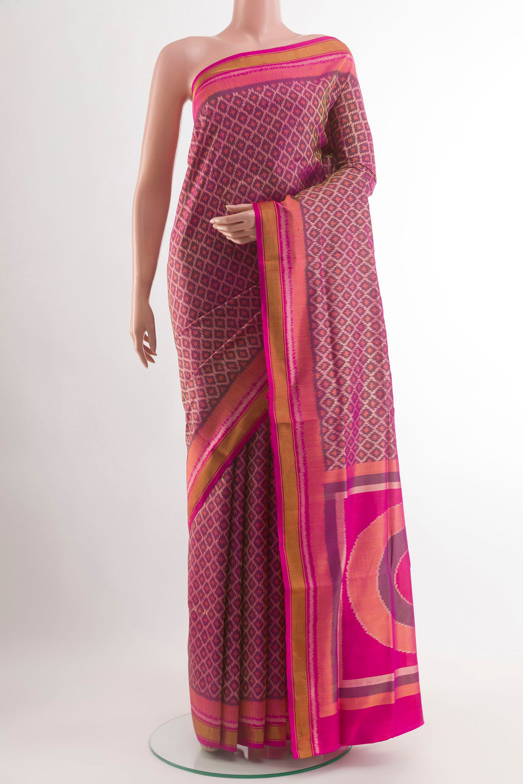 Magenta Rajkot Patola Silk Saree with Ikat design on the body and Zari Border.  displayed on a mannequin