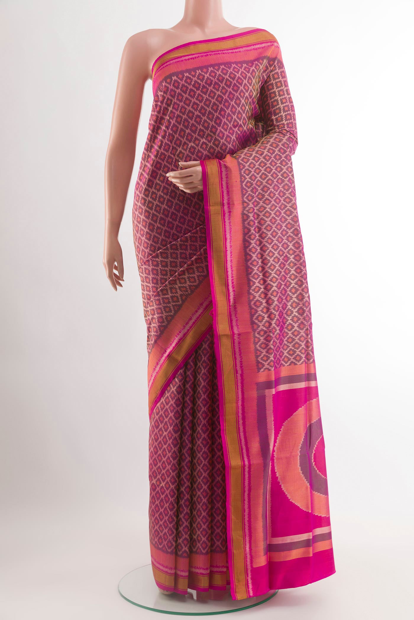 Magenta Rajkot Patola Silk Saree with Ikat design on the body and Zari Border.  displayed on a mannequin