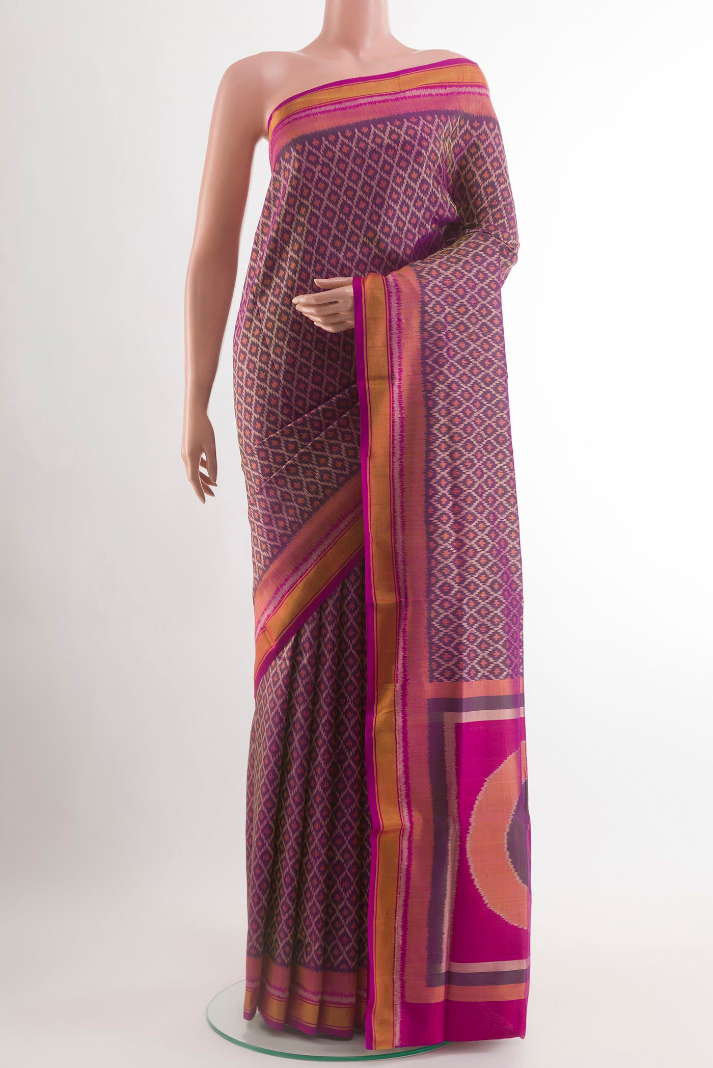 Purple Rajkot Patola Silk Saree with Ikat design on the body and Zari Border.  displayed on a mannequin