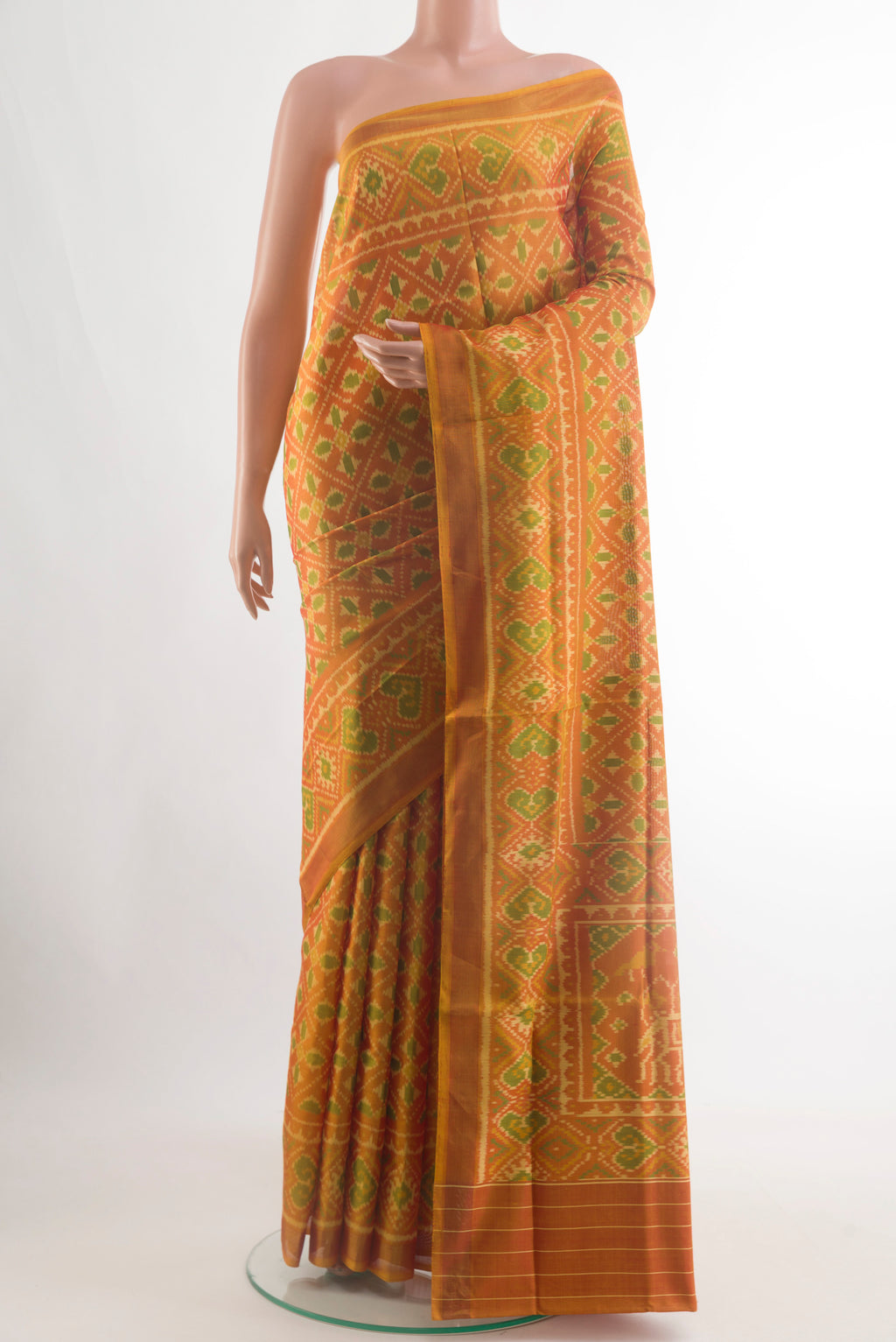 Rust Rajkot Patola Silk Saree with Pure Ikat on the body and Ikat Border.  displayed on a mannequin