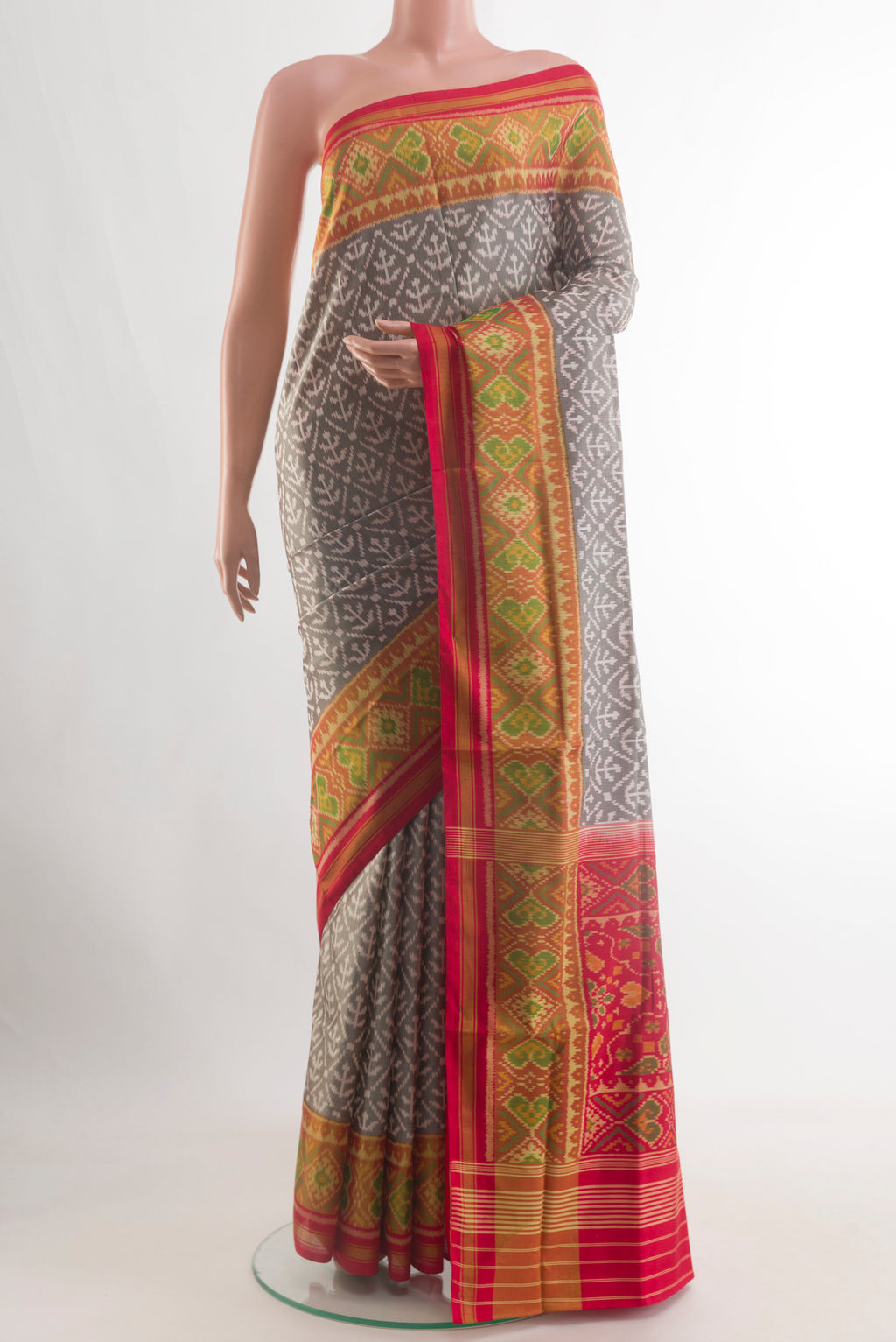Grey Rajkot Patola Silk Saree with Pure Ikat on the body and Ikat Border.  displayed on a mannequin