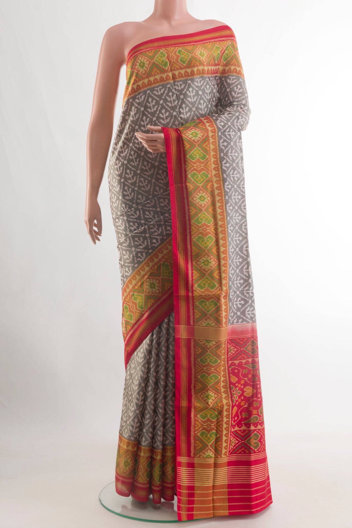 Grey Rajkot Patola Silk Saree with Pure Ikat on the body and Ikat Border.  displayed on a mannequin