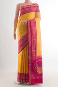 Pure Silk Yellow Rajkot Patola Saree with Pure Ikat on the body and Zari Border.  displayed on a mannequin