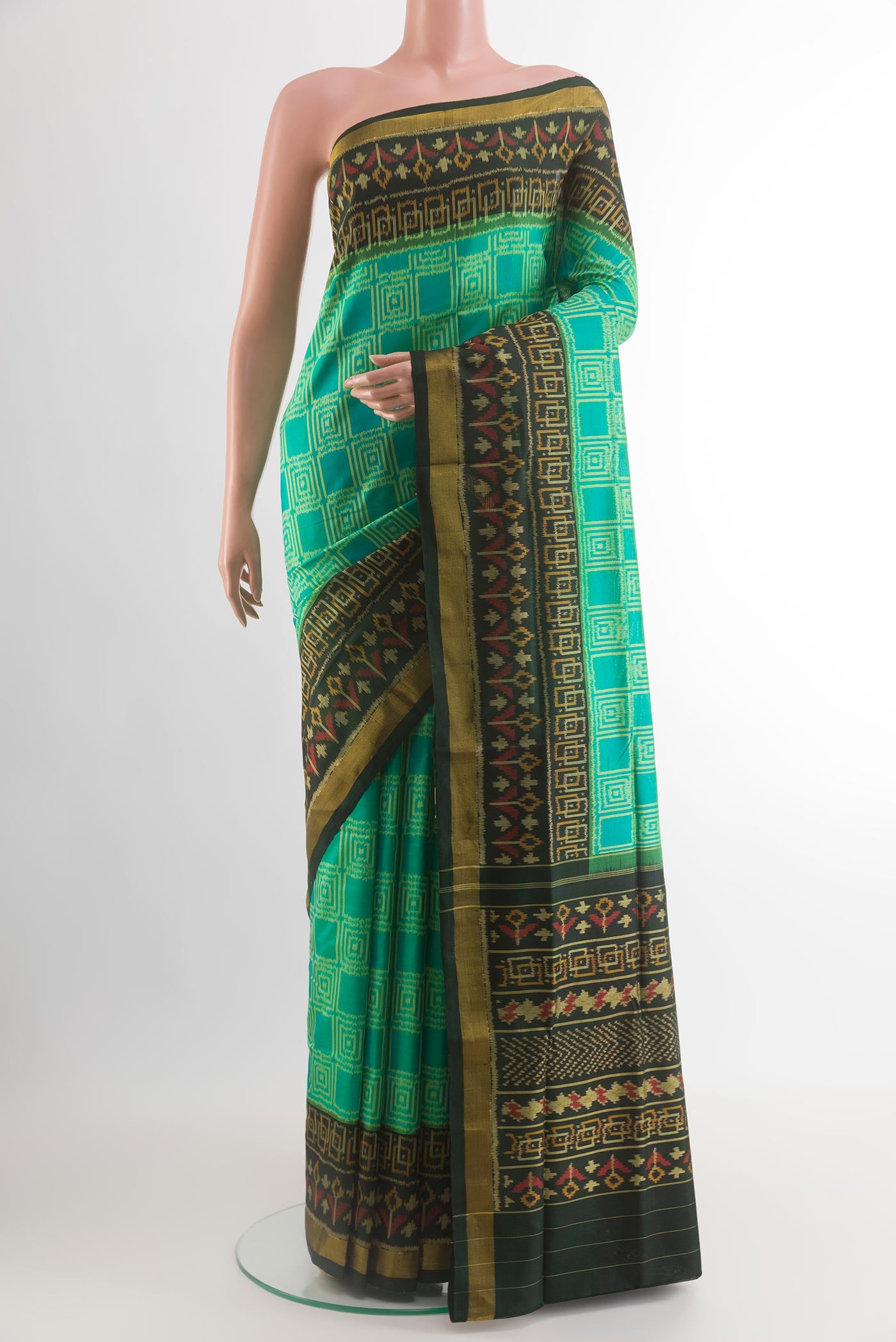 Sea Green Rajkot Patola Silk Saree with Pure Ikat on the body and Ikat Border.  displayed on a mannequin