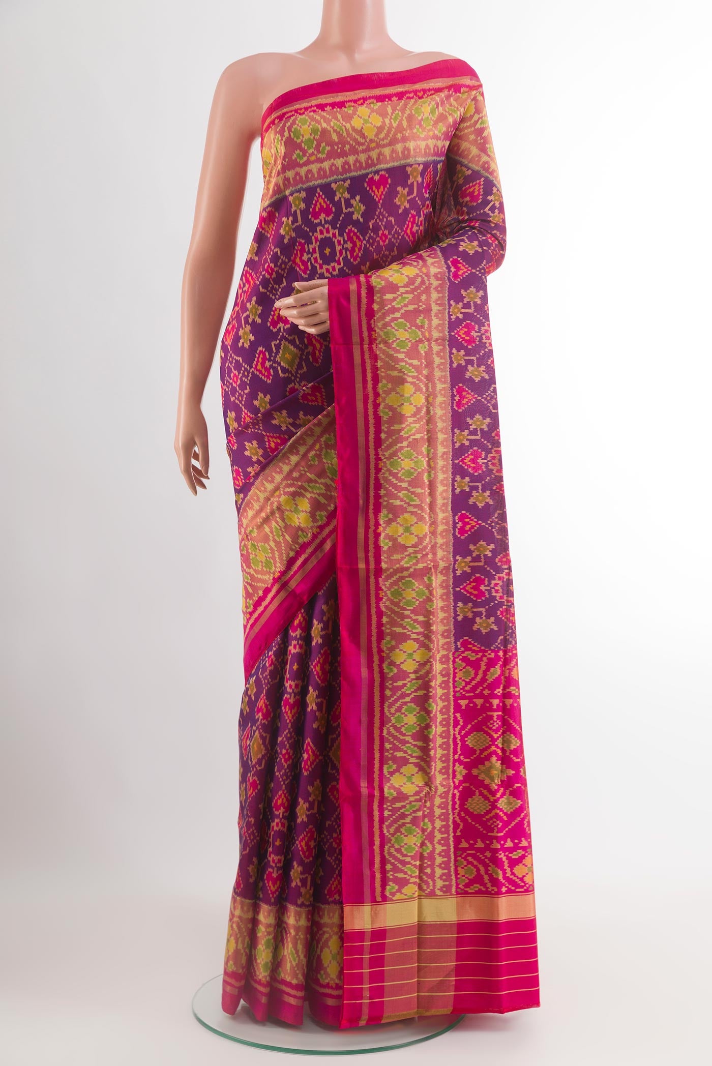 Purple Rajkot Patola Silk Saree with Pure Ikat on the body and Ikat Border.  displayed on a mannequin