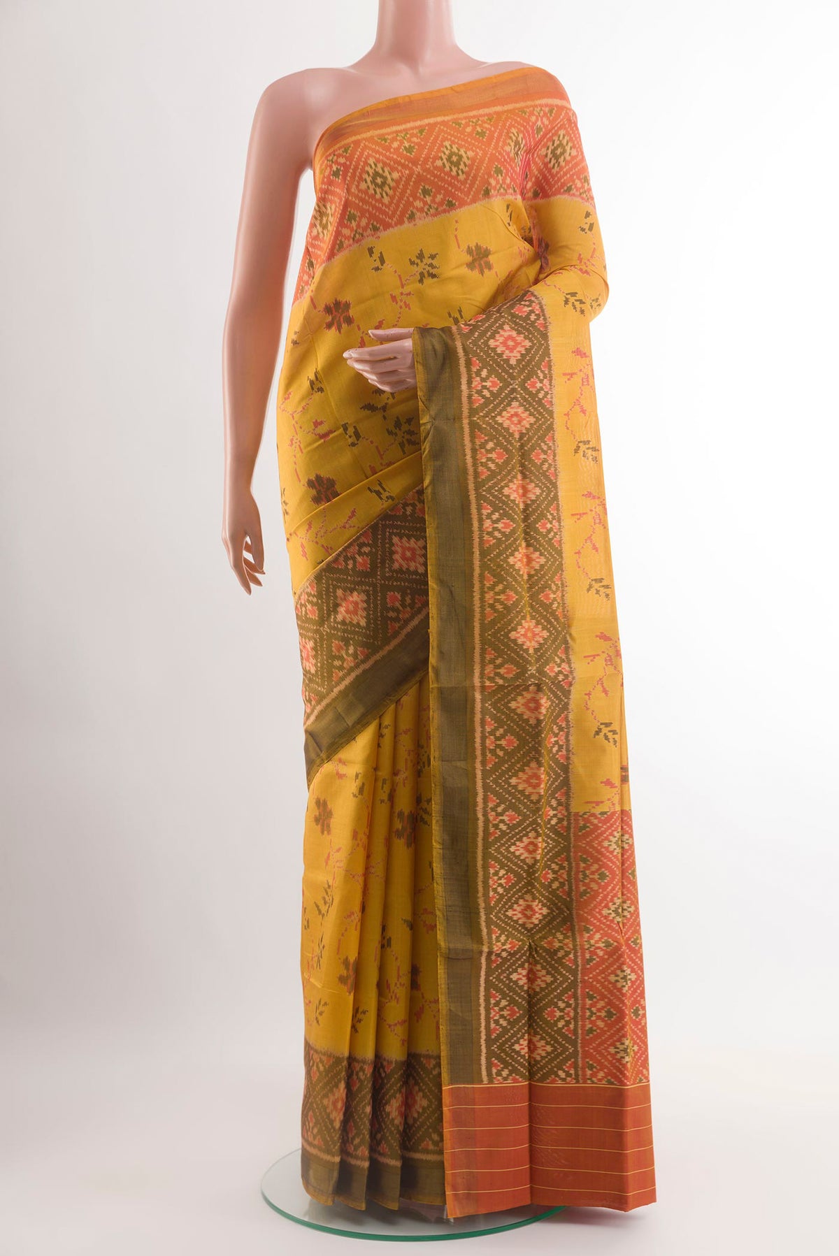 Yellow Rajkot Patola Silk Saree with Ikat design on the body and Ikat Border.  displayed on a mannequin