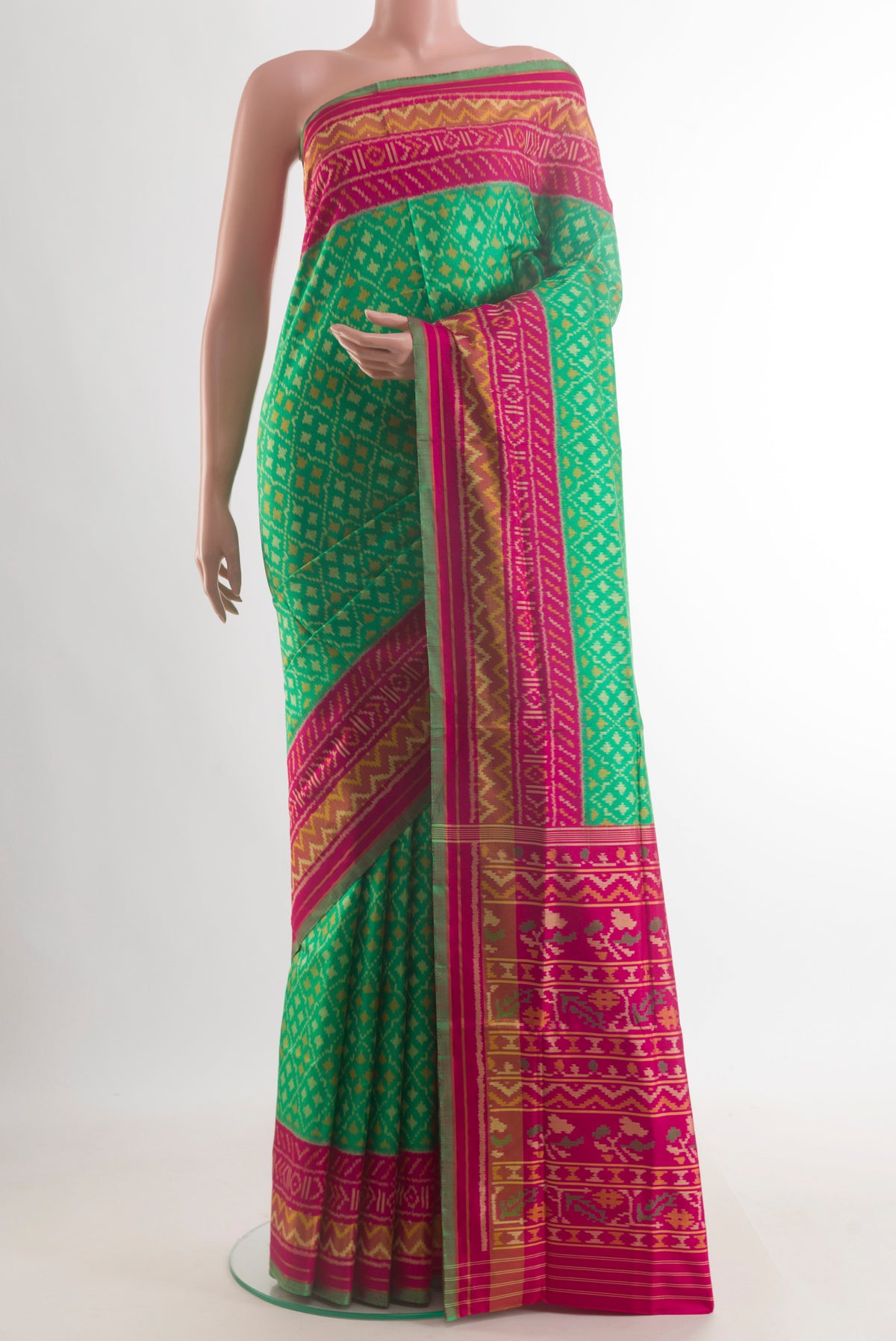 Pure Silk Green Rajkot Patola Saree with Pure Ikat on the body and Ikat Border.  displayed on a mannequin