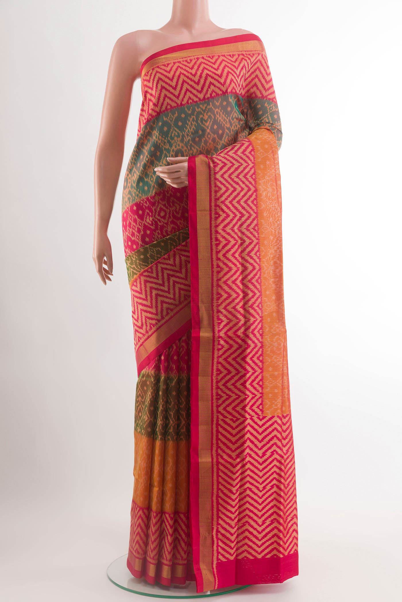 Multi Color Rajkot Patola Silk Saree with Ikat design on the body and Zari Border.  displayed on a mannequin