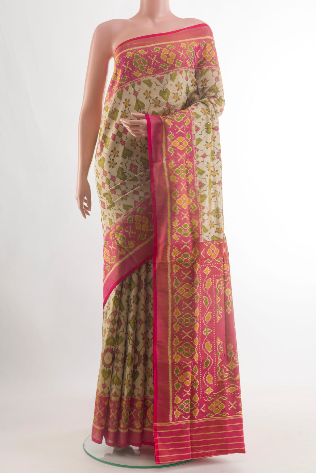 Beige Rajkot Patola Silk Saree with Pure Ikat on the body and Ikat Border.  displayed on a mannequin