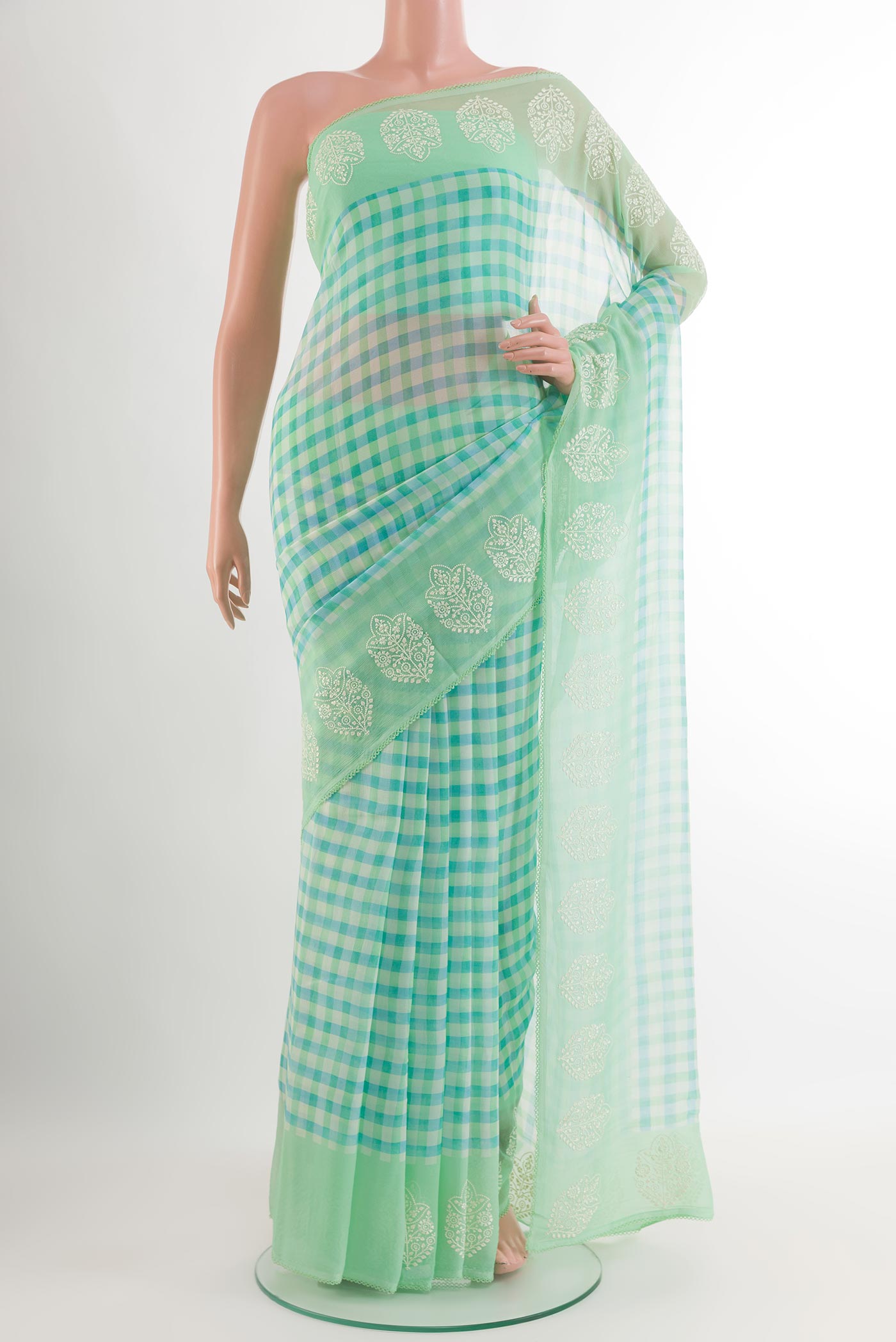 Green Chiffon Saree with Checked design on the body and Embroidery Border.  displayed on a mannequin