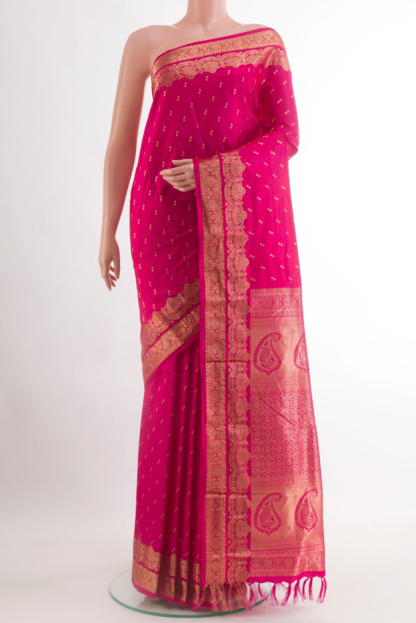 Pink Kanjivaram Silk Saree with Zari Butta on the body and Zari Border.  displayed on a mannequin