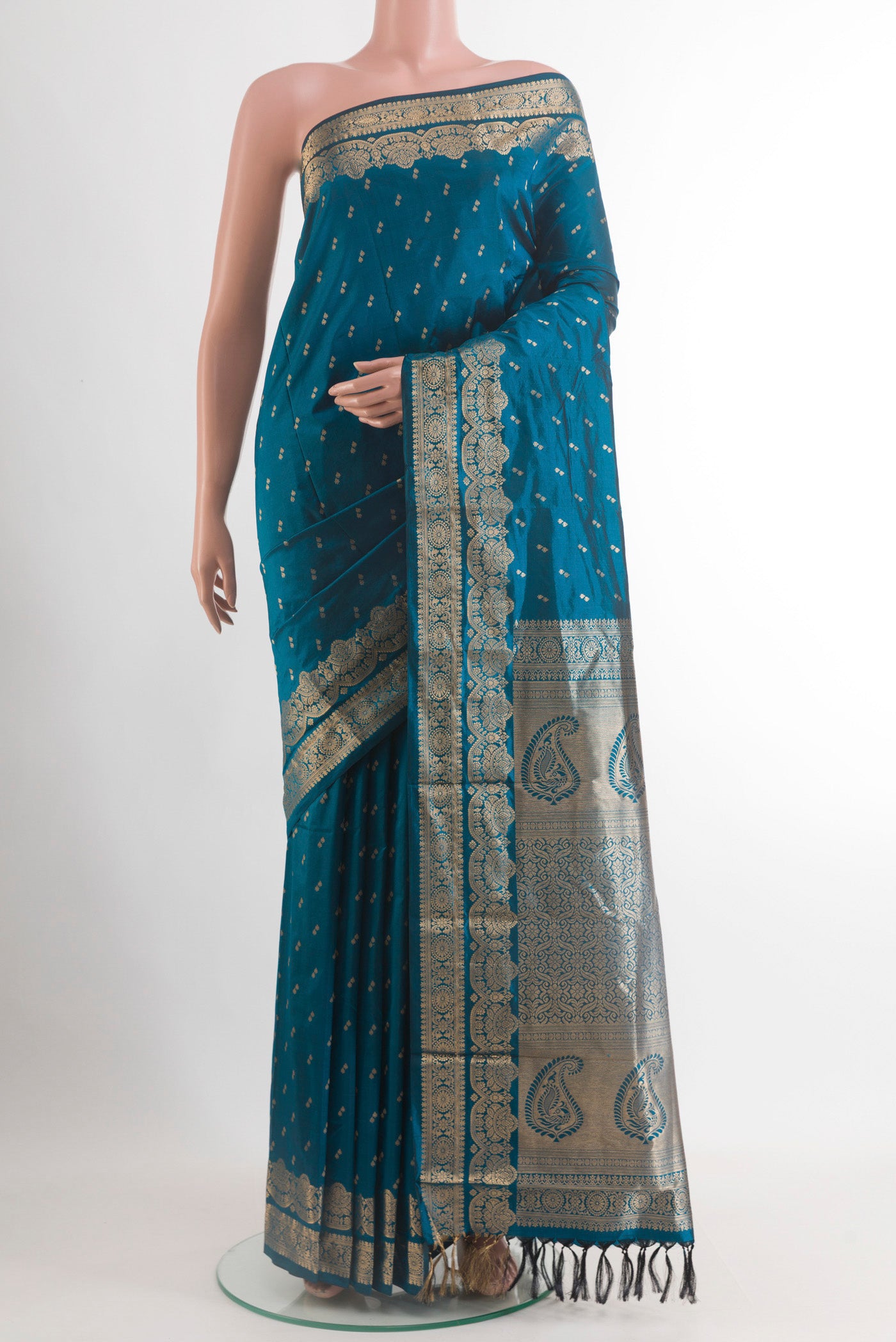 Peacock Blue Kanjivaram Silk Saree with Zari Butta on the body and Zari Border.  displayed on a mannequin