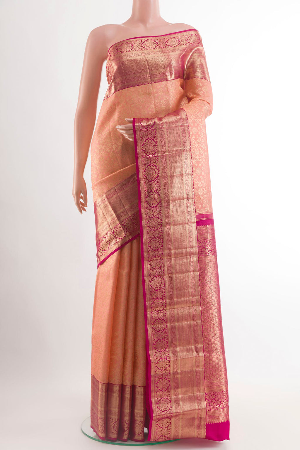 Peach Kanchipuram Silk Saree with Zari Brocade on the body and Zari Border.  displayed on a mannequin