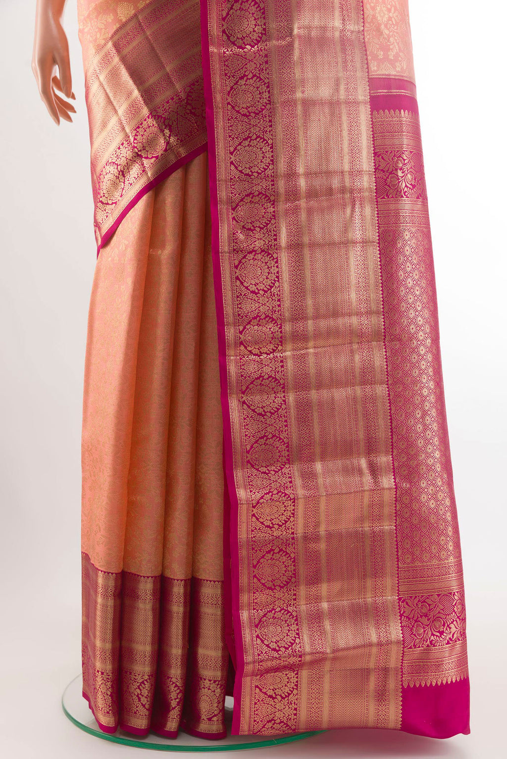 Pleats and pallu of Peach Kanchipuram Silk Saree with Zari Brocade on the body and Zari Border. 