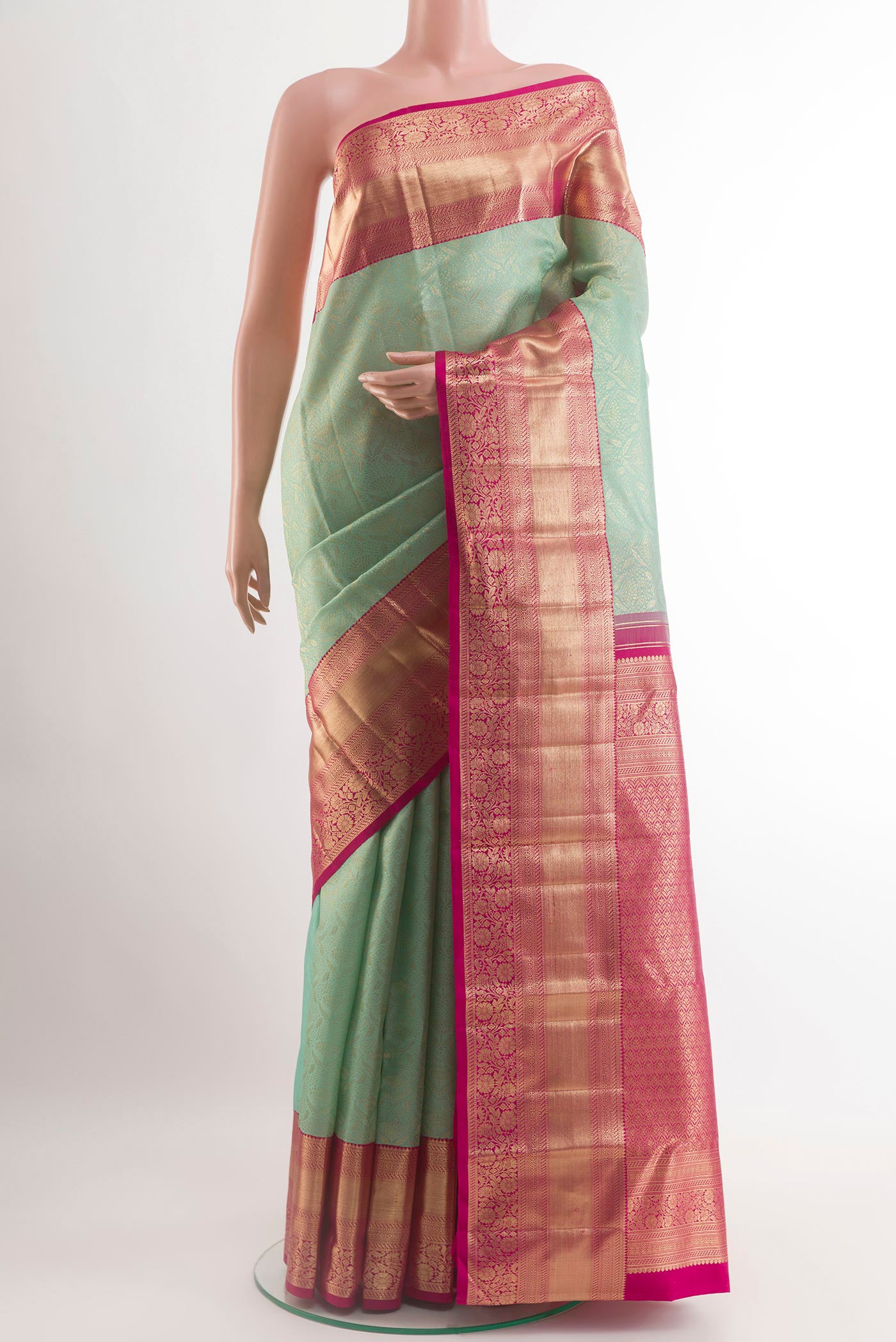 Mint Green Kanchipuram Silk Saree with Zari Brocade on the body and Zari Border.  displayed on a mannequin