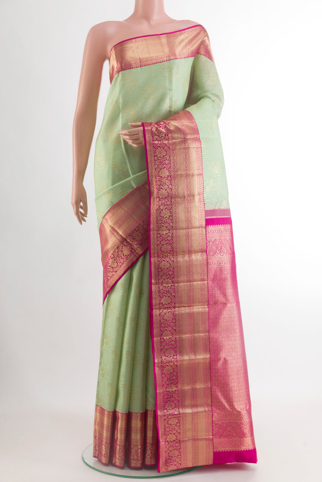 Light Green Kanchipuram Silk Saree with Zari Brocade on the body and Zari Border.  displayed on a mannequin