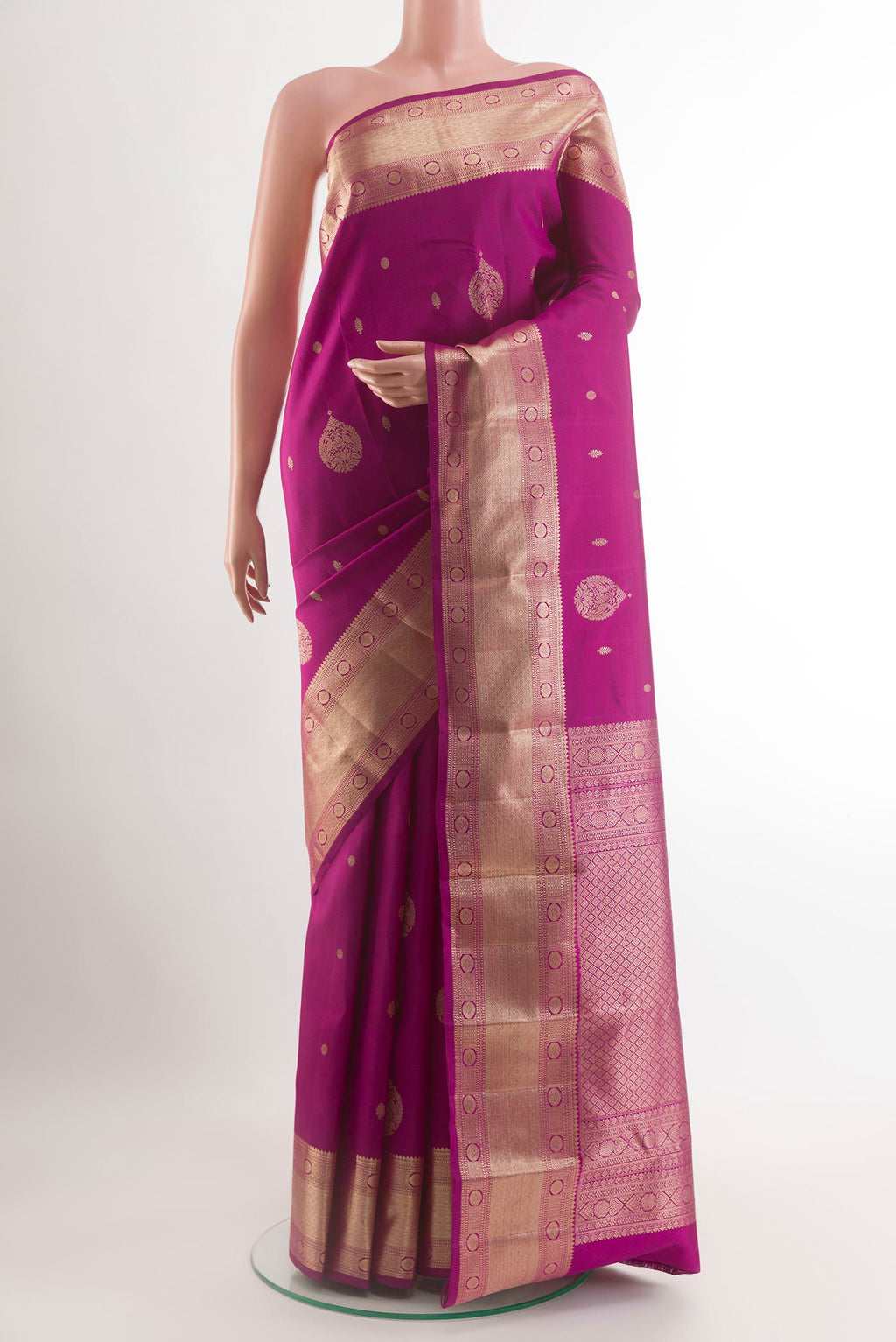 Magenta Kanjivaram Silk Saree with Zari Butta on the body and Zari Border.  displayed on a mannequin
