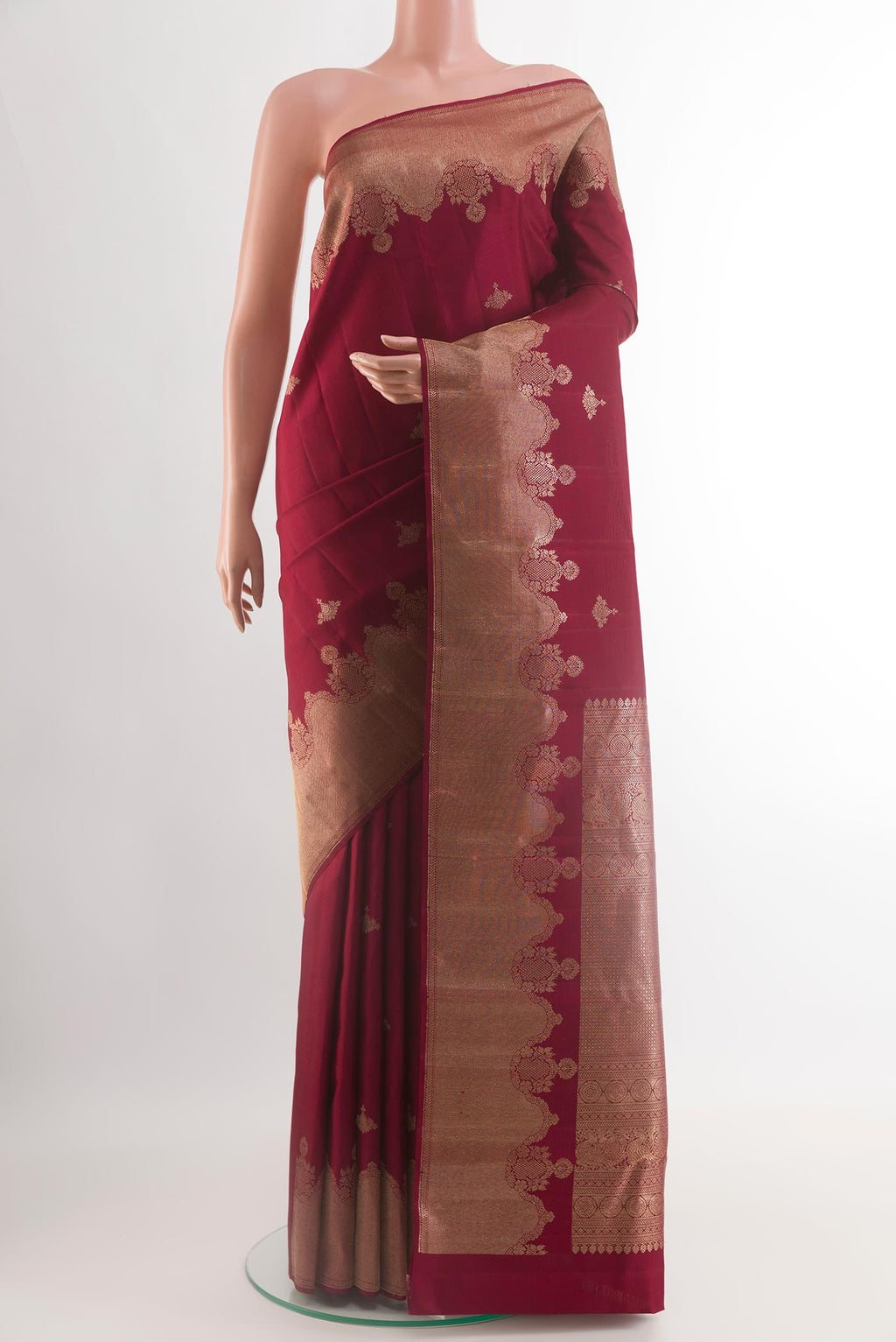 Maroon Kanjivaram Silk Saree with Zari Butta on the body and Zari Border.  displayed on a mannequin