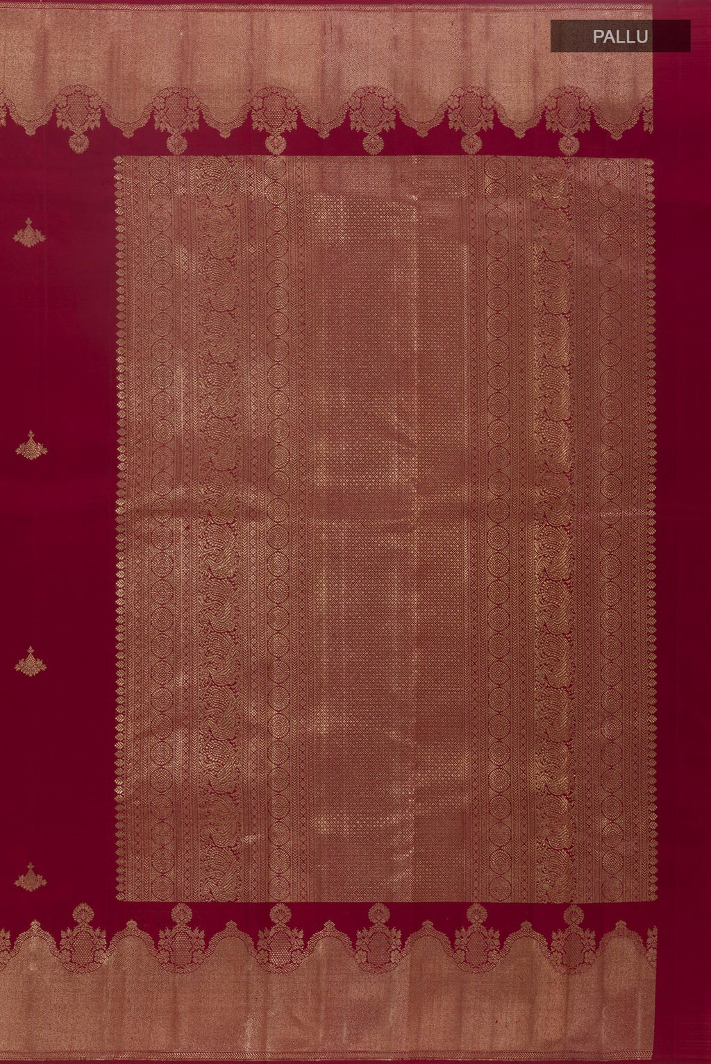 Close up image of the pallu of Maroon Kanjivaram Silk Saree with Zari Butta on the body and Zari Border. 