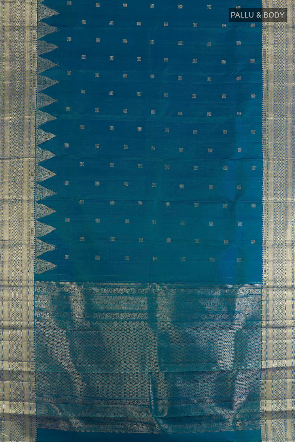 Flat view of Pure Silk Peacock Blue Kanjivaram Saree with Zari Butta on the body and Zari Border. 