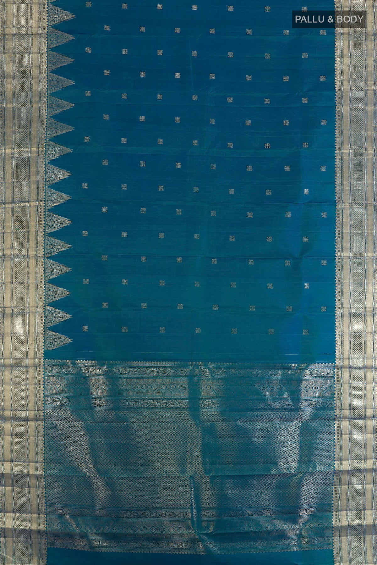 Flat view of Pure Silk Peacock Blue Kanjivaram Saree with Zari Butta on the body and Zari Border. 