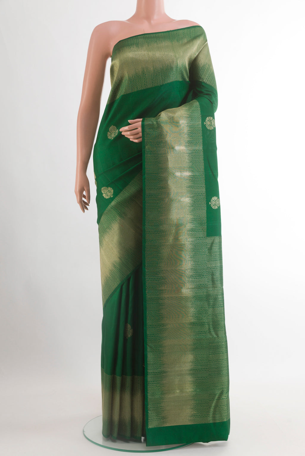 Green Kanjivaram Silk Saree with Zari Butta on the body and Zari Border.  displayed on a mannequin