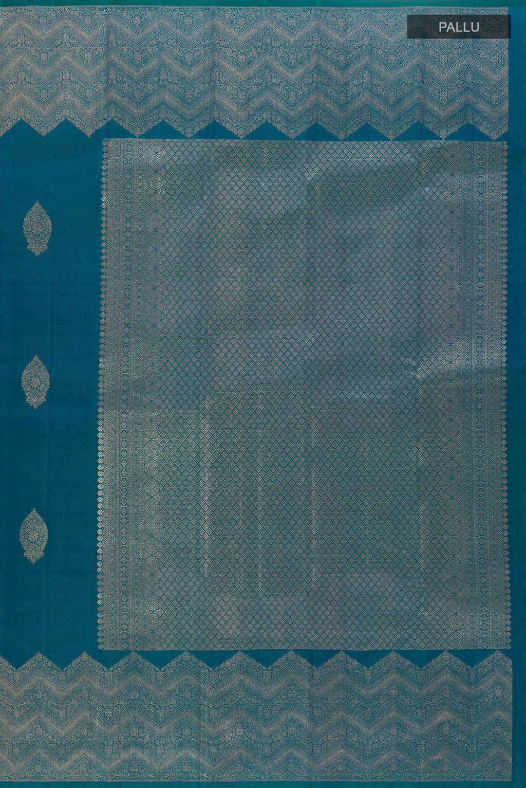 Close up image of the pallu of Peacock Blue Kanjivaram Silk Saree with Zari Butta on the body and Zari Border. 