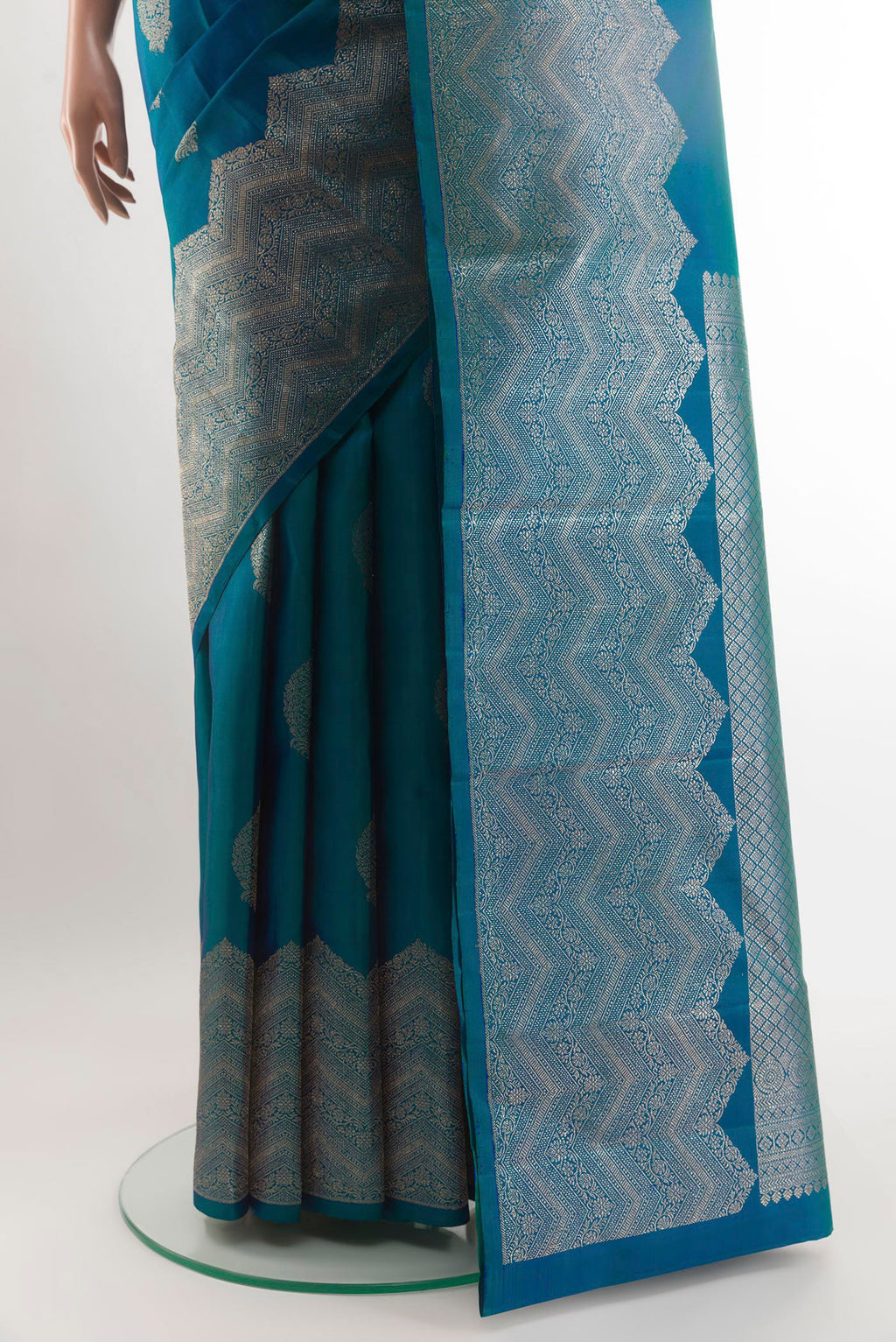 Pleats and pallu of Peacock Blue Kanjivaram Silk Saree with Zari Butta on the body and Zari Border. 