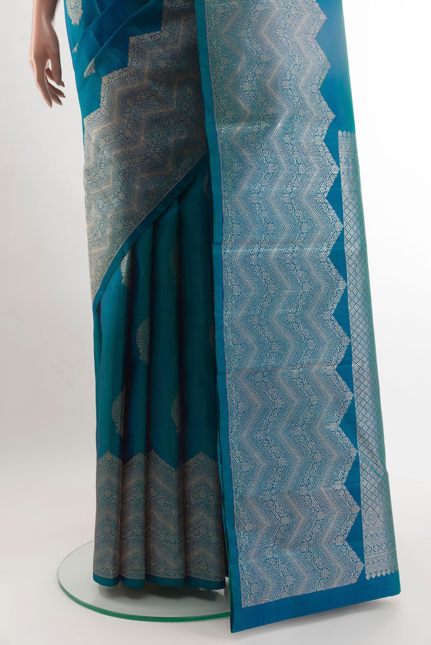 Pleats and pallu of Peacock Blue Kanjivaram Silk Saree with Zari Butta on the body and Zari Border. 