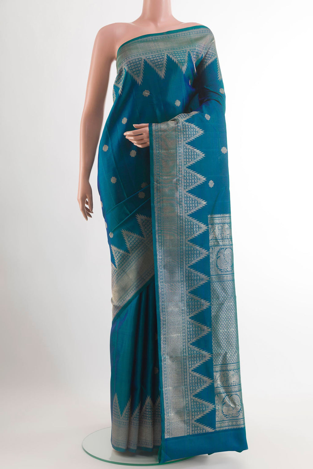 Peacock Blue Kanchipuram Silk Saree with Zari Butta on the body and Temple Border.  displayed on a mannequin