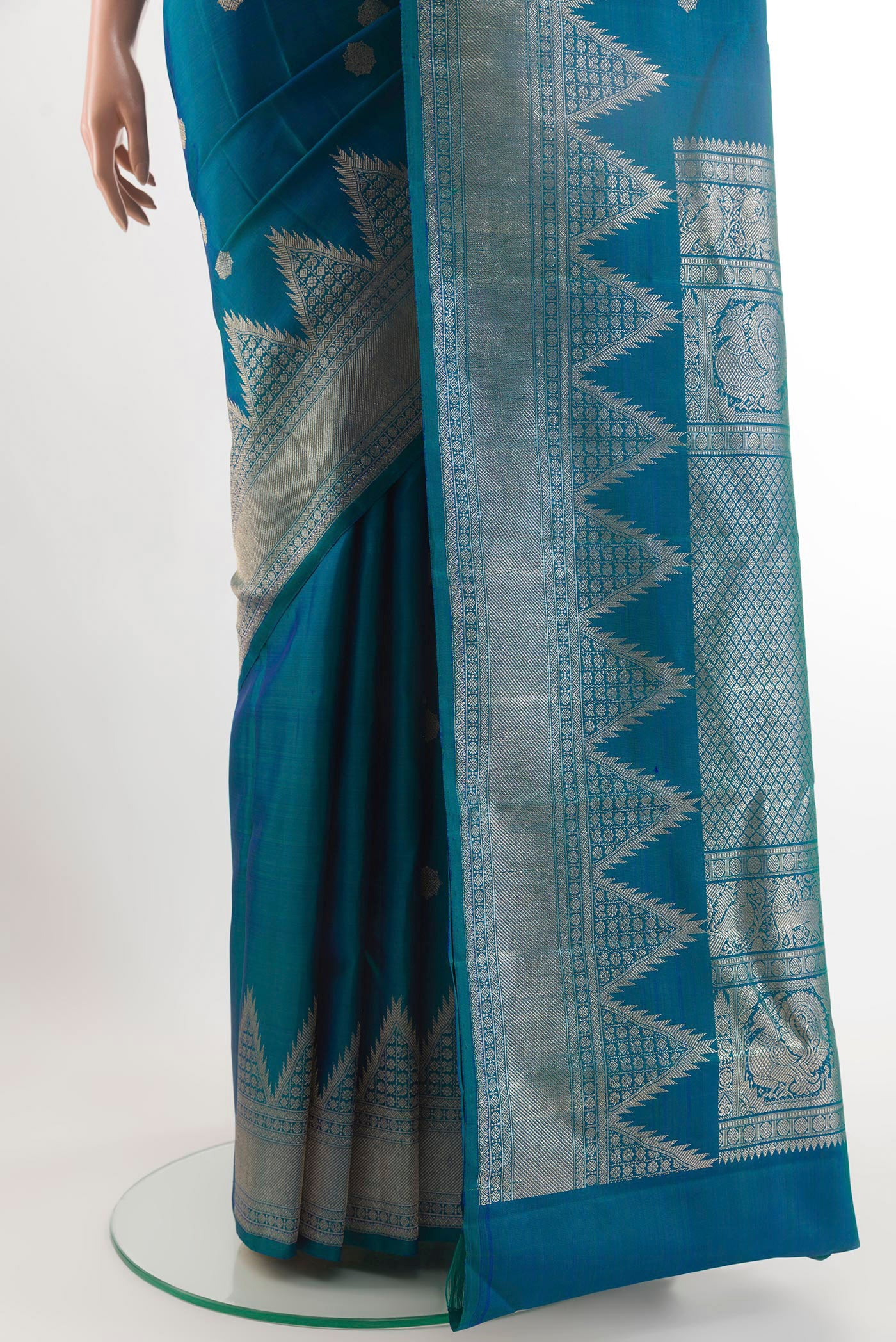 Pleats and pallu of Peacock Blue Kanchipuram Silk Saree with Zari Butta on the body and Temple Border. 