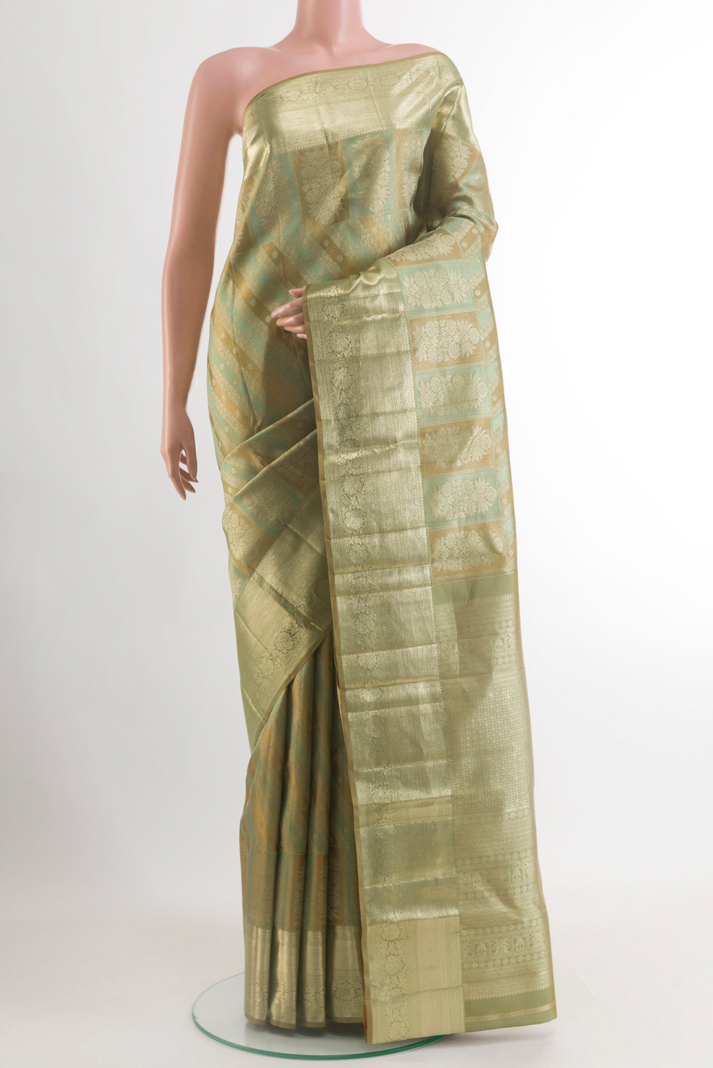 Green Kanjivaram Silk Saree with Zari Brocade on the body and Zari Border.  displayed on a mannequin