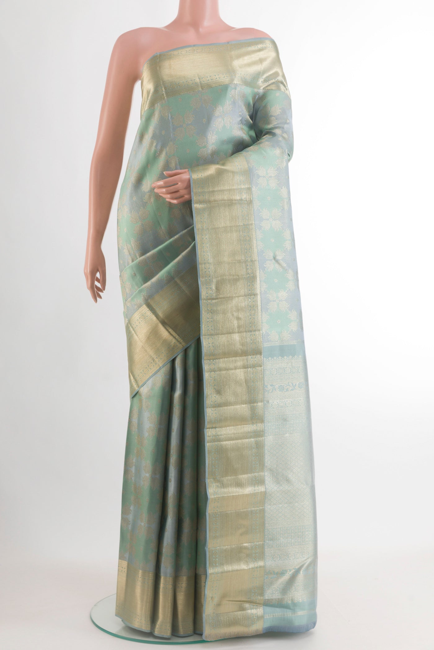Grey Kanjivaram Tissue Silk Saree with Zari Brocade on the body and Zari Border.  displayed on a mannequin