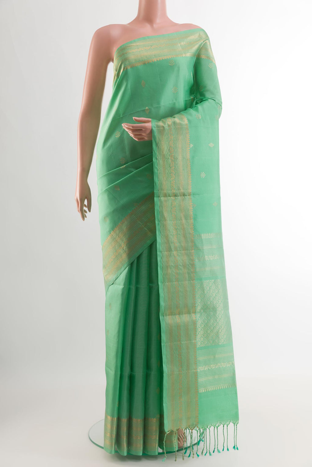 Sea Green Soft Silk Saree with Zari Butta on the body and Zari Border.  displayed on a mannequin