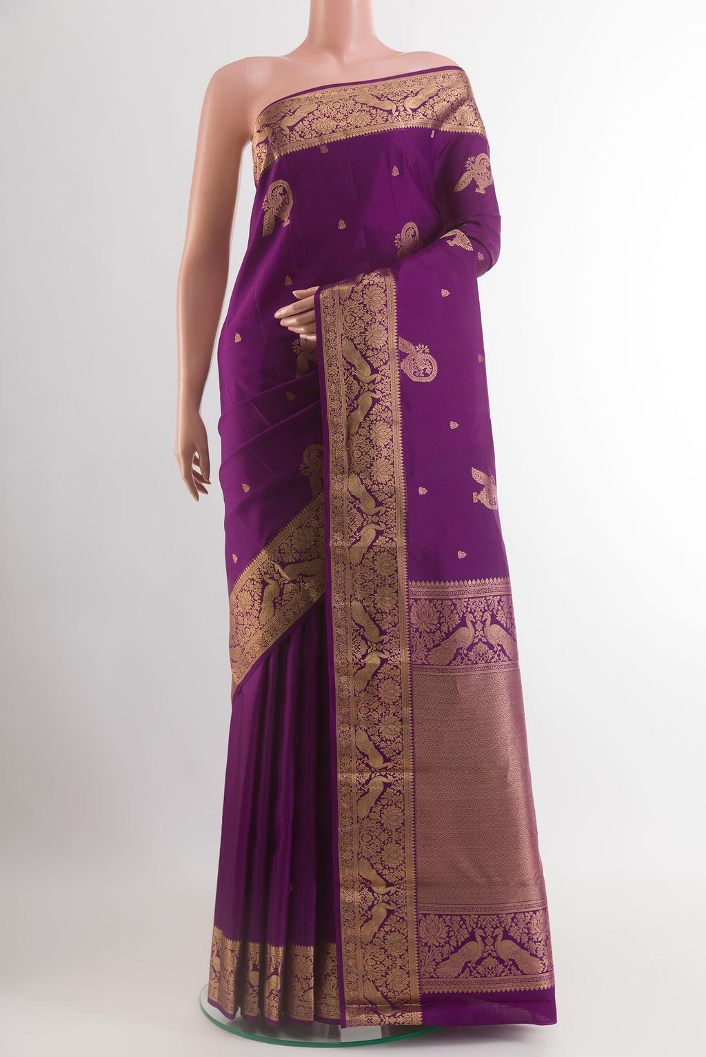 Purple Kanjivaram Silk Saree with Zari Butta on the body and Zari Border.  displayed on a mannequin