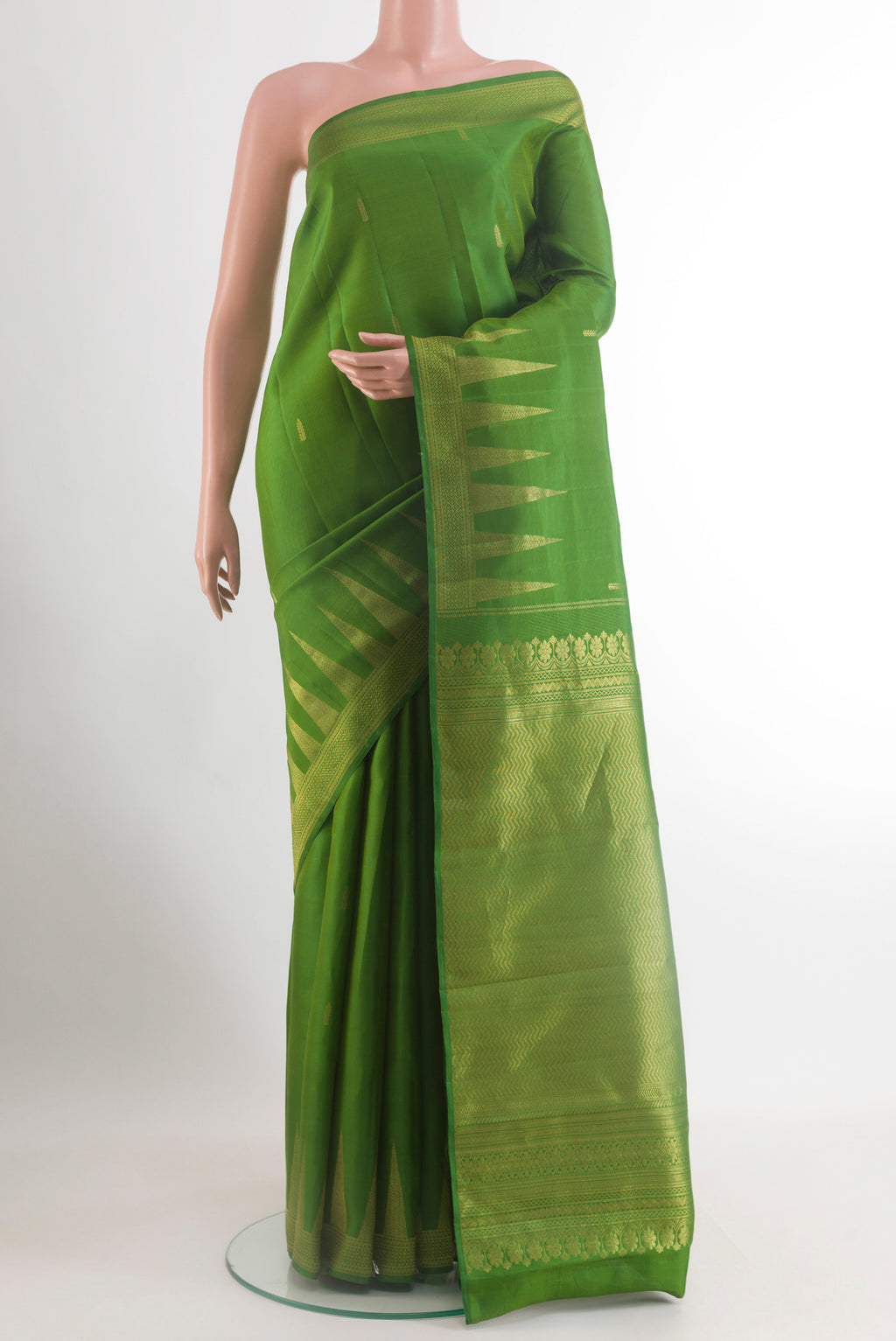 Green Kanchipuram Silk Saree with Zari Butta on the body and Zari Border.  displayed on a mannequin