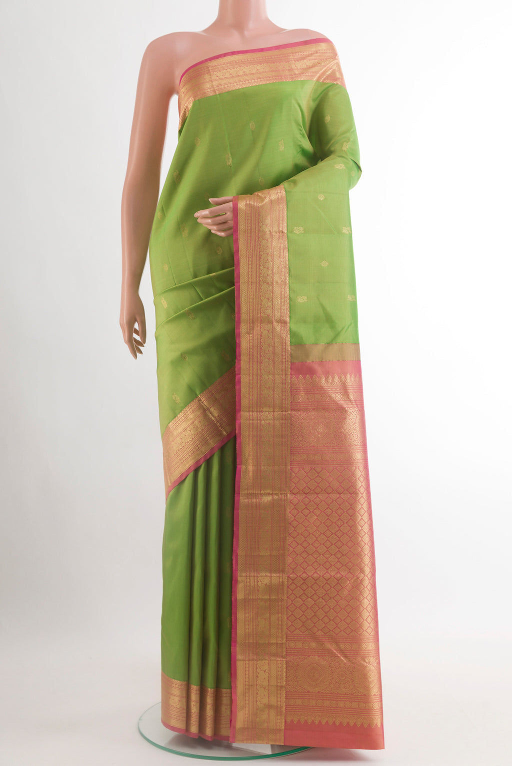 Green Kanchipuram Silk Saree with Zari Butta on the body and Zari Border.  displayed on a mannequin