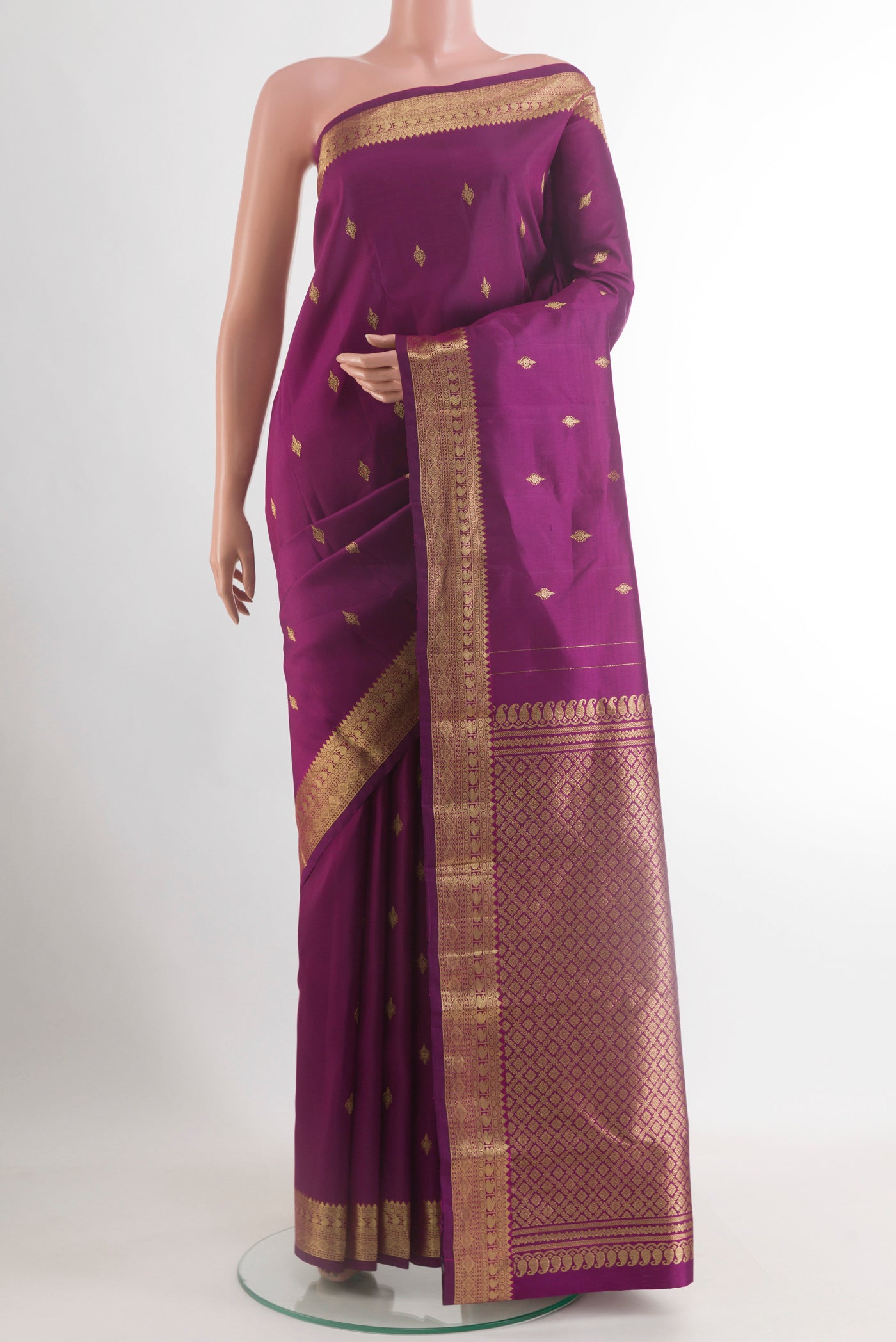 Purple Kanchipuram Silk Saree with Zari Butta on the body and Zari Border.  displayed on a mannequin