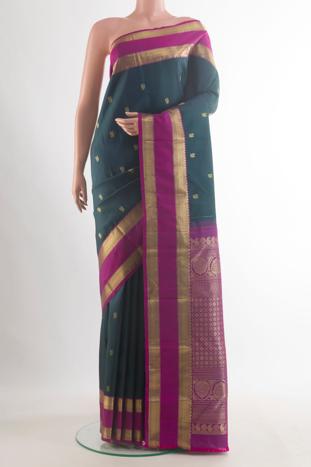 Pure Silk Green Kanchipuram Saree with Zari Butta on the body and Zari Border.  displayed on a mannequin
