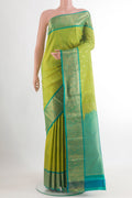 Green Kanchipuram Silk Saree with Zari Butta on the body and Zari Border.  displayed on a mannequin