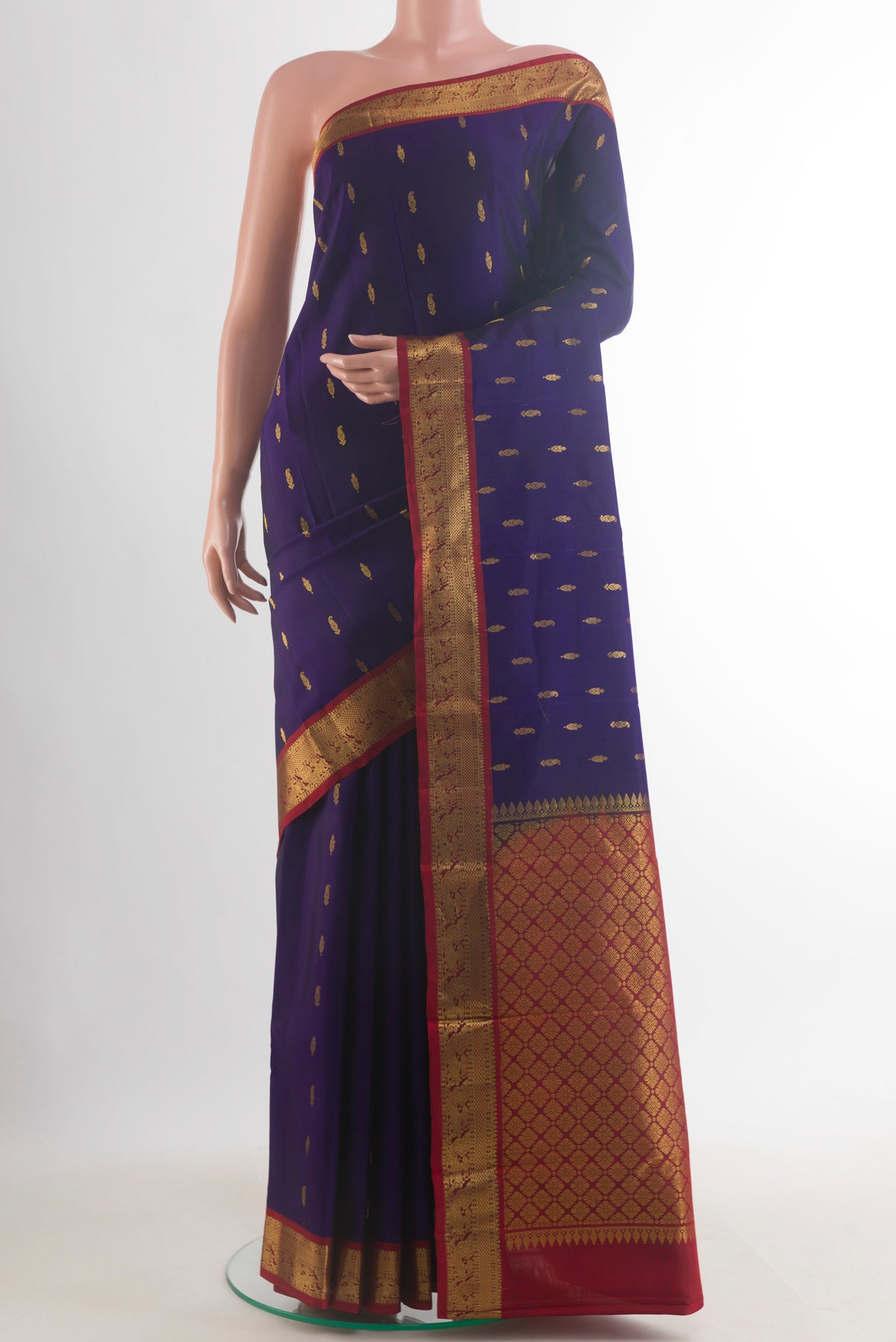 Pure Silk Navy Blue Kanchipuram Saree with Zari Butta on the body and Zari Border.  displayed on a mannequin