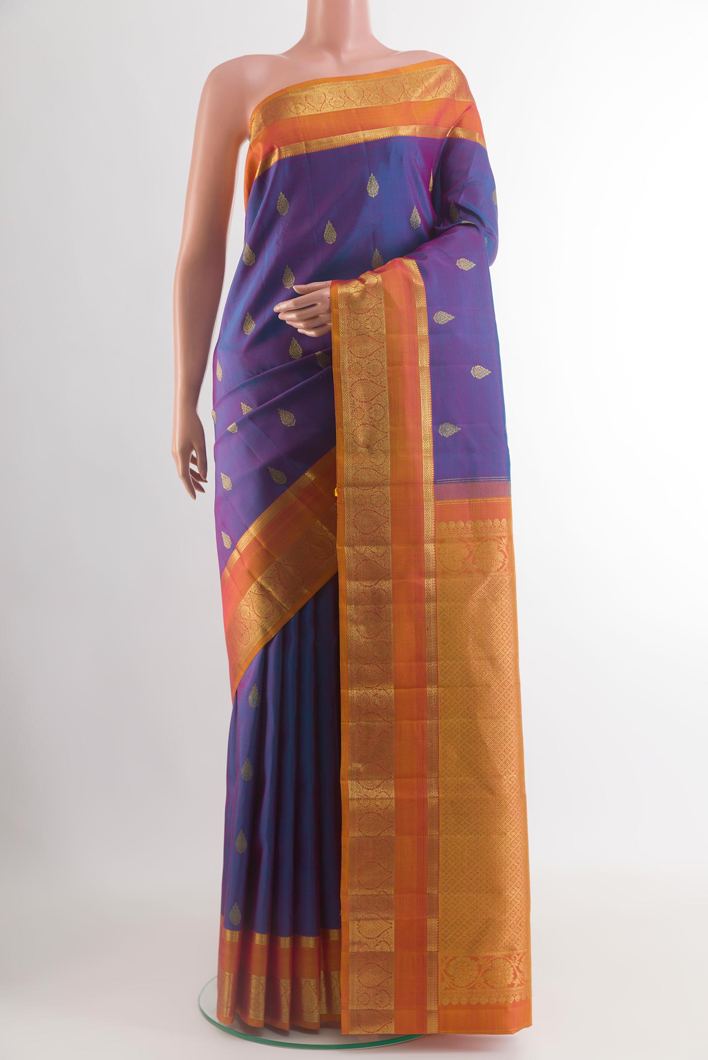 Purple Kanchipuram Silk Saree with Zari Butta on the body and Zari Border.  displayed on a mannequin