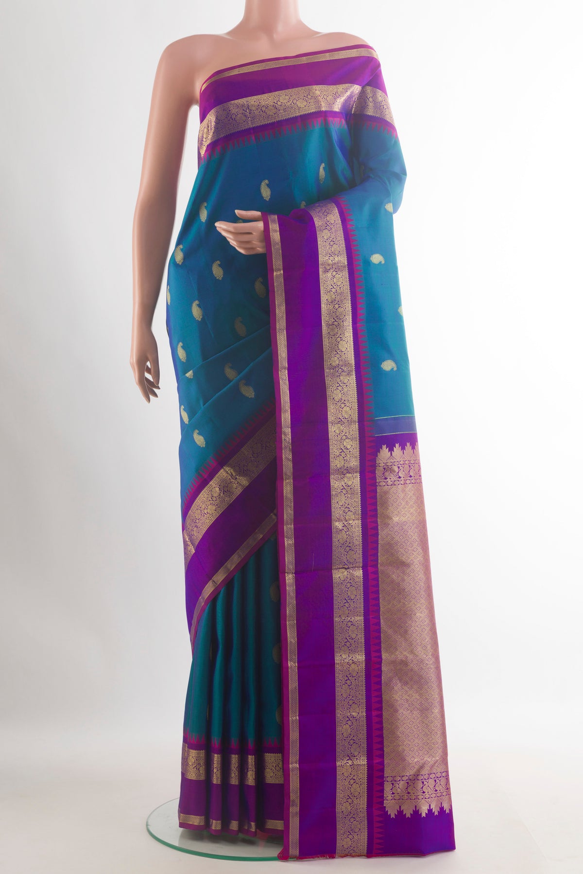 Pure Silk Peacock Blue Kanchipuram Saree with Zari Butta on the body and Zari Border.  displayed on a mannequin