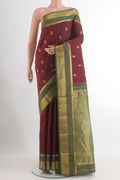 Maroon Kanchipuram Silk Saree with Zari Butta on the body and Zari Border.  displayed on a mannequin