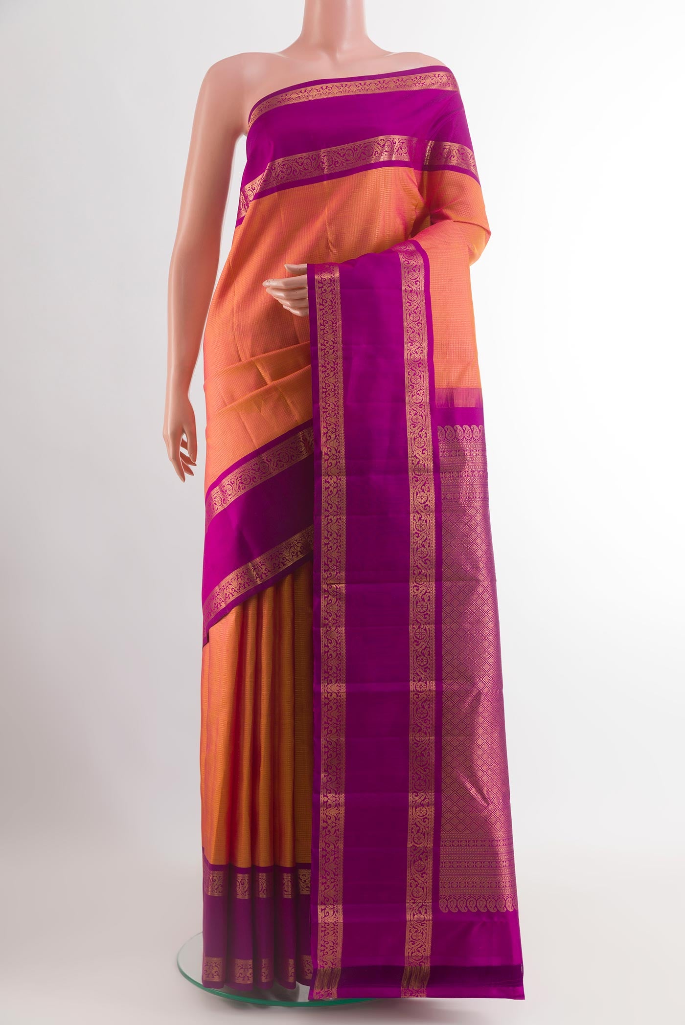 Peach Kanchipuram Silk Saree with Stripes on the body and Zari Border.  displayed on a mannequin