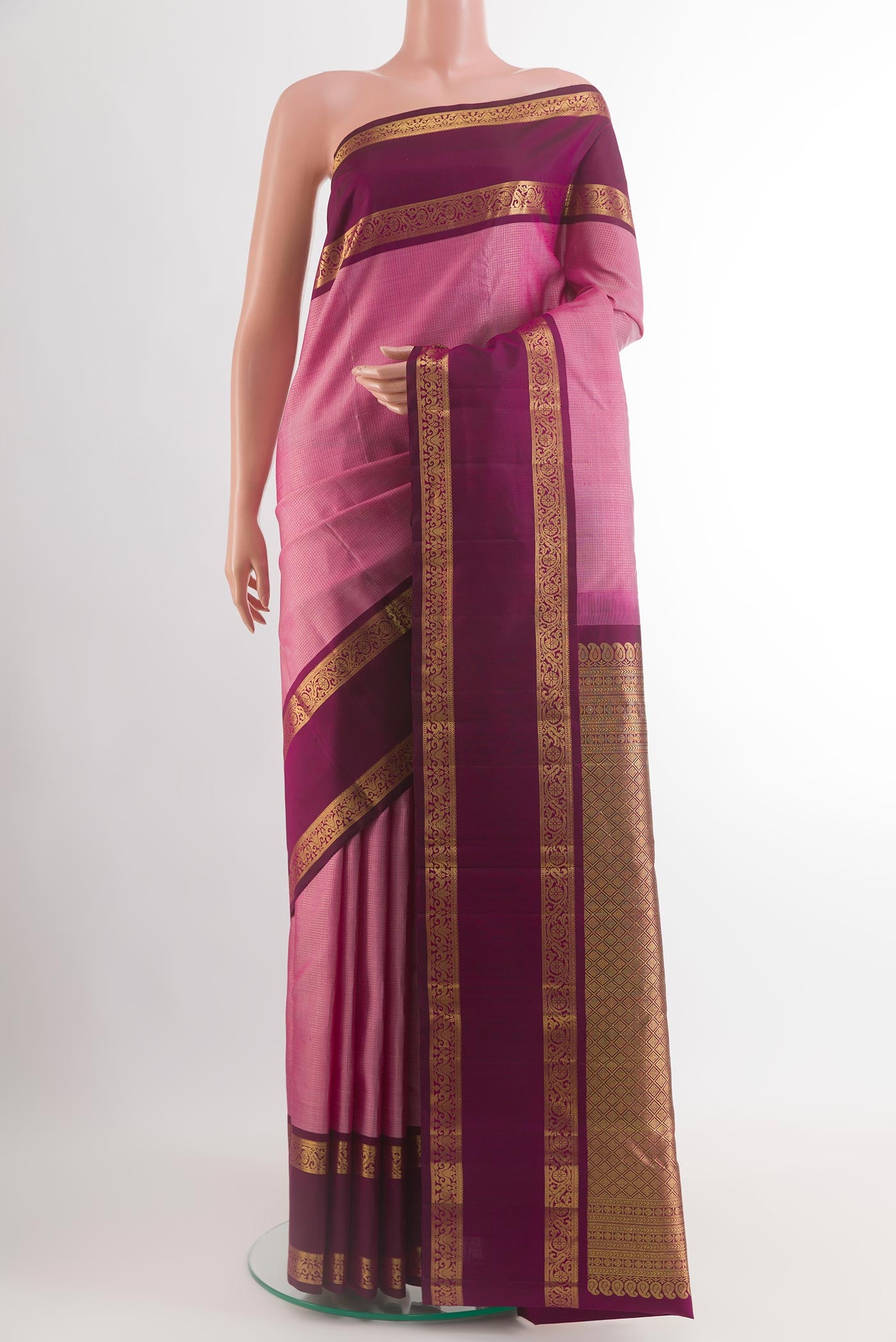 Pink Kanchipuram Silk Saree with Checked design on the body and Zari Border.  displayed on a mannequin