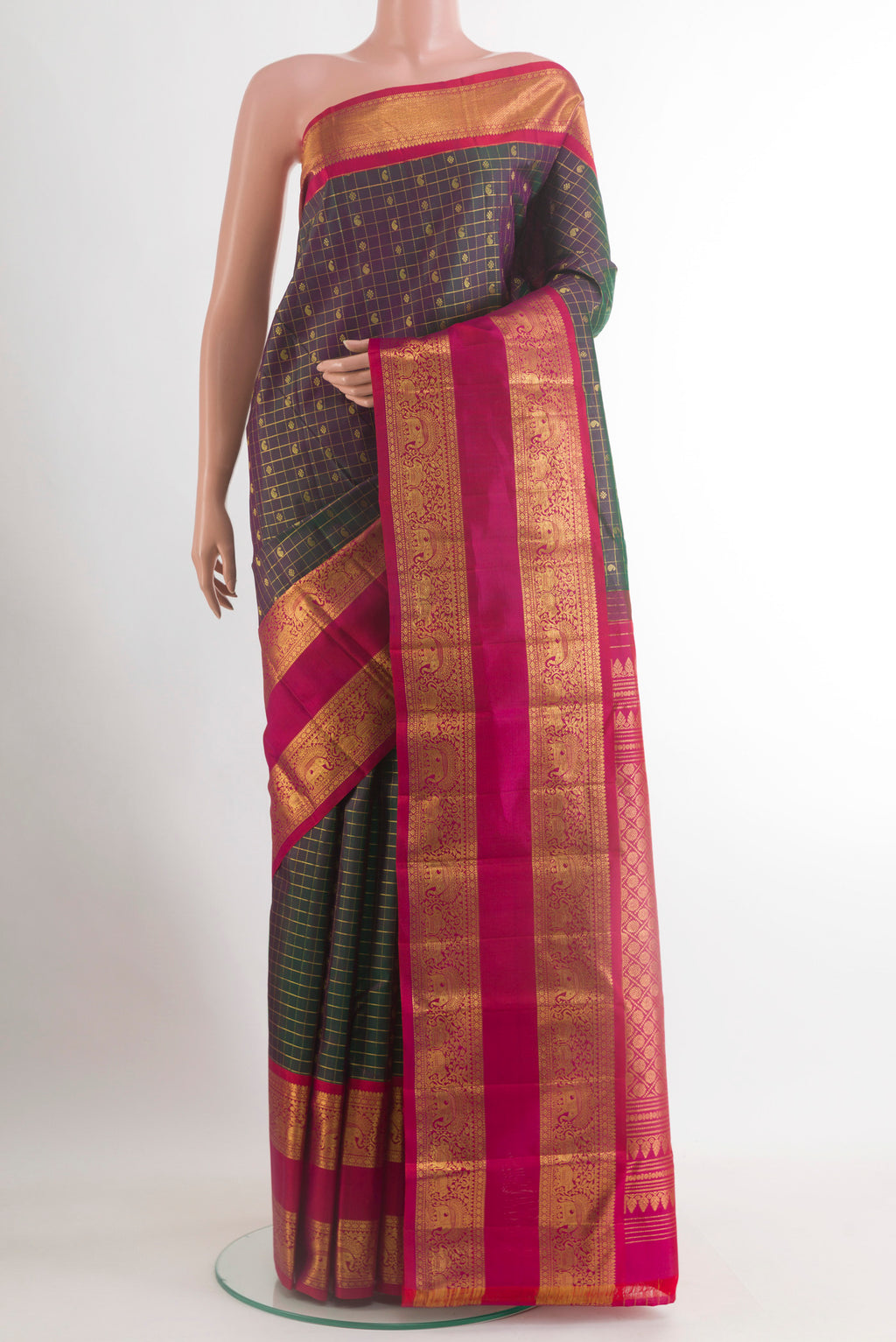 Green Kanjivaram Silk Saree with Checked design on the body and Zari Border.  displayed on a mannequin