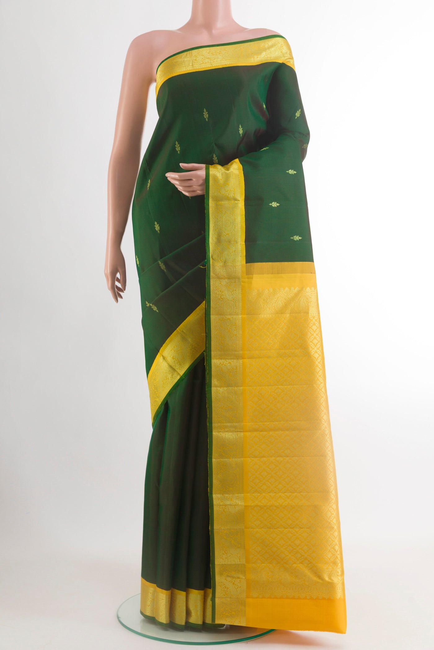 Bottle Green Kanjivaram Silk Saree with Zari Butta on the body and Zari Border.  displayed on a mannequin